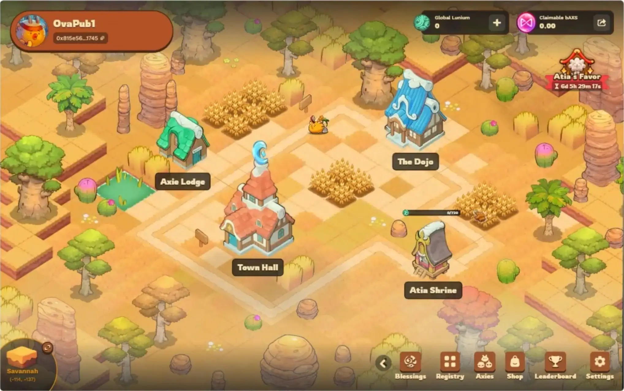In this screenshot from Axie Infinity, an isometric view displays a savannah village environment featuring buildings labeled Town Hall, The Dojo, and Atia Shrine alongside various trees and crops on the grid.
