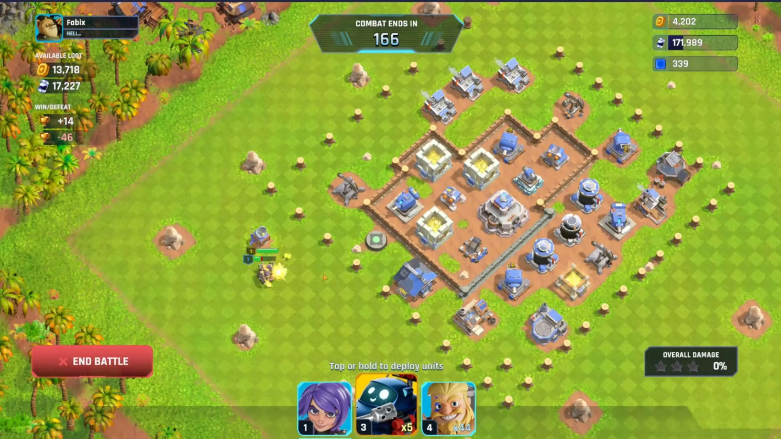 In this screenshot from Heroes Of Mavia, an isometric view shows a fortified base of blue and grey structures on a green grid map where combat units are deployed near the entrance as a timer counts down.