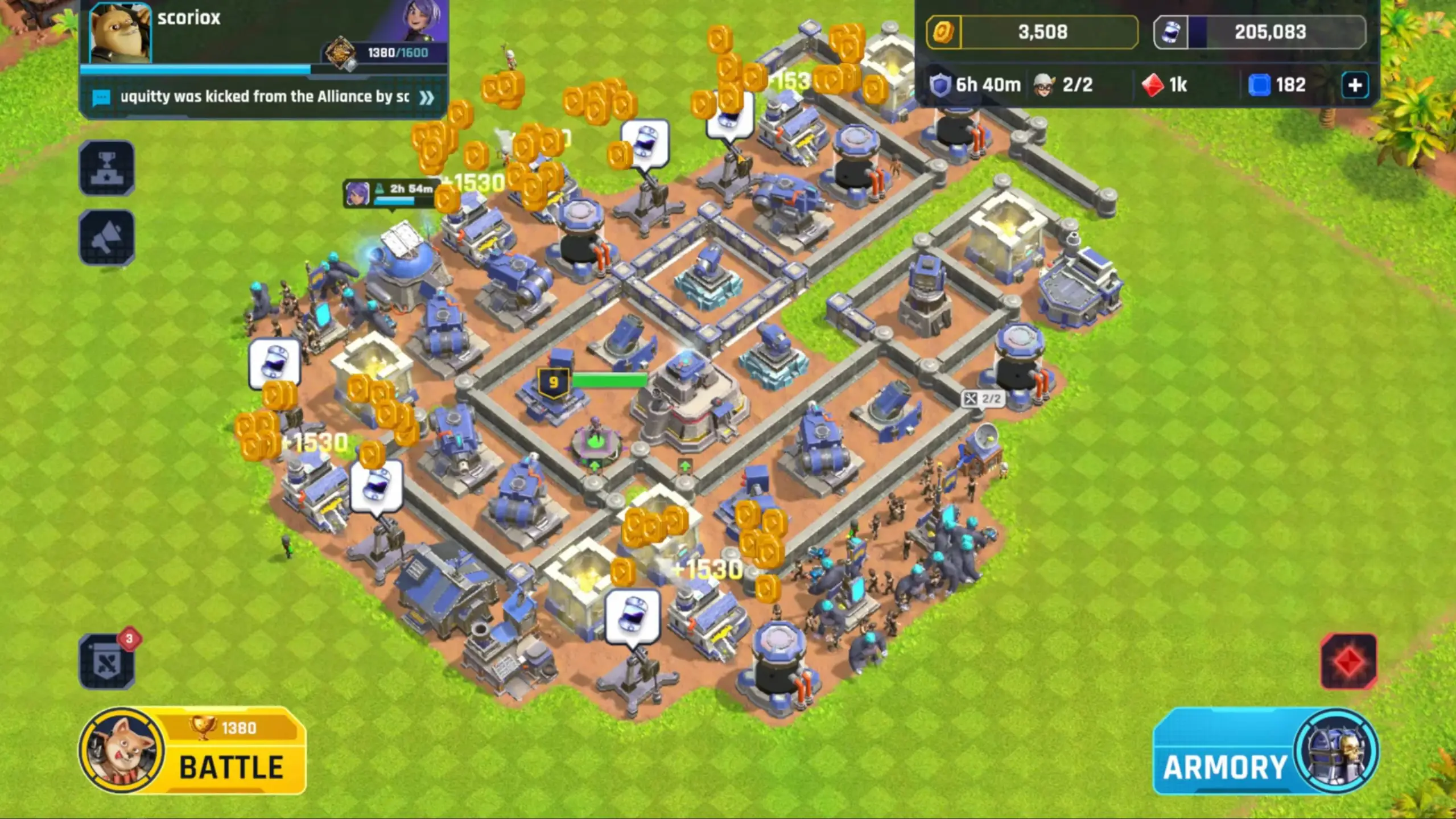 In this screenshot from Heroes Of Mavia, an isometric view shows a fortified base on green grass featuring numerous blue defensive structures and buildings surrounded by walls with floating gold coins indicating resource collection.