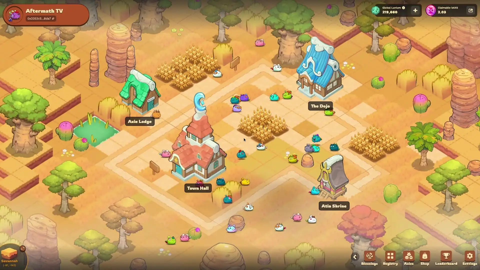 In this screenshot from Axie Infinity: Terrariums, numerous small creatures wander through an arid village setting that features labeled buildings including the Town Hall, The Dojo, and Atia Shrine amidst crops and desert vegetation.