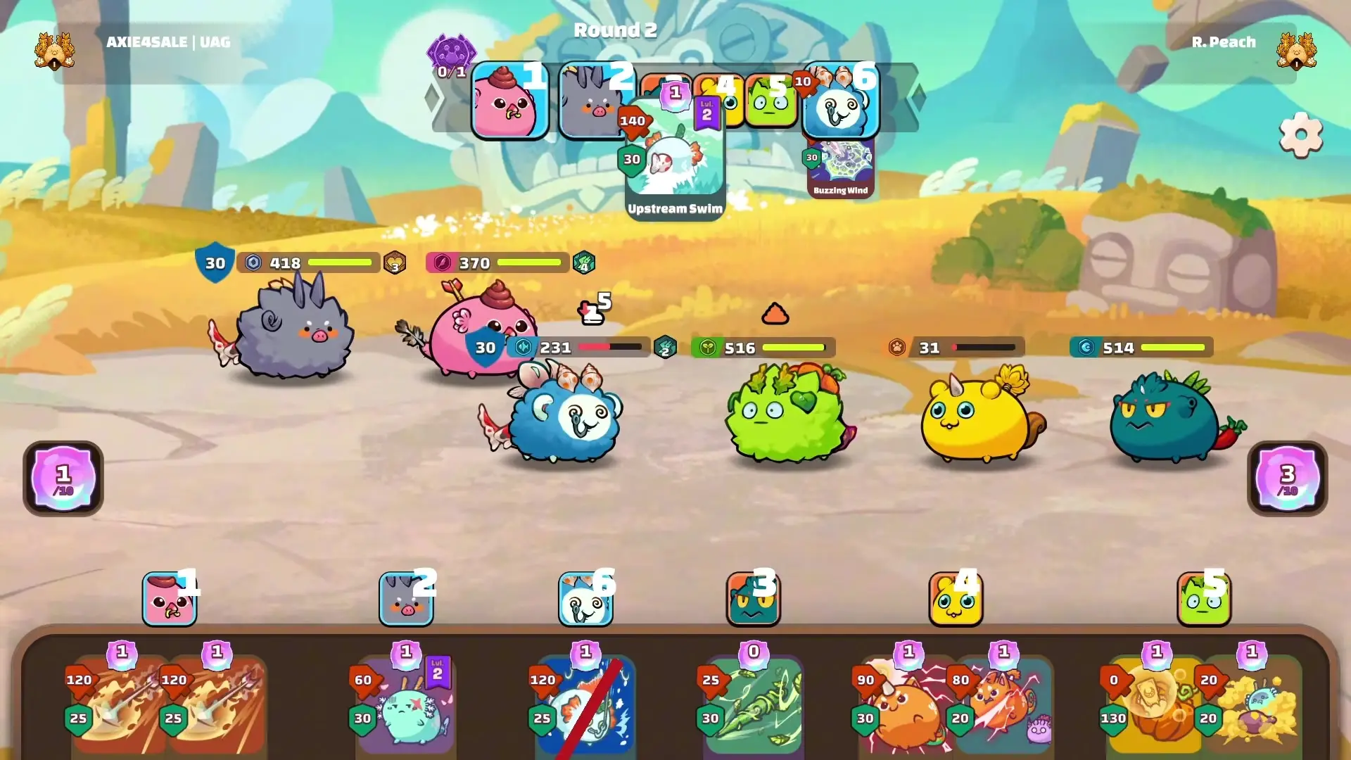 This screenshot from Axie Classic shows a battle in progress during Round 2, featuring two teams of colorful creatures on an outdoor field while the player manages a hand of ability cards at the bottom of the screen.